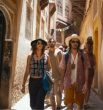 Adventurous tourists on an educational luxury trip exploring the historic and narrow streets in Morocco.