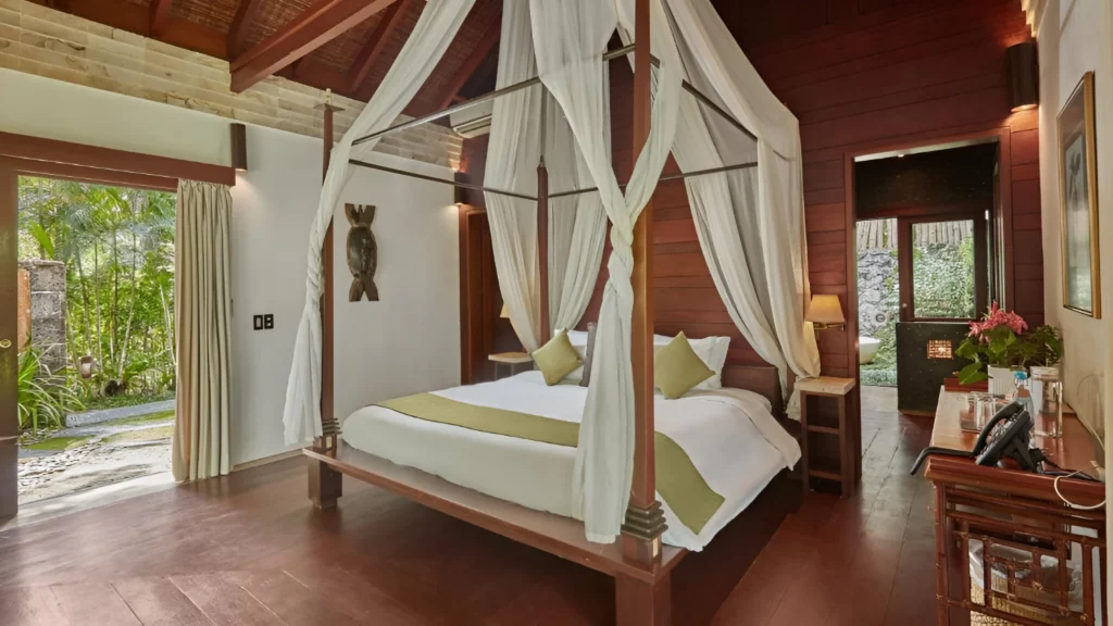 A cozy bedroom with a beautiful canopy bed and warm wooden flooring