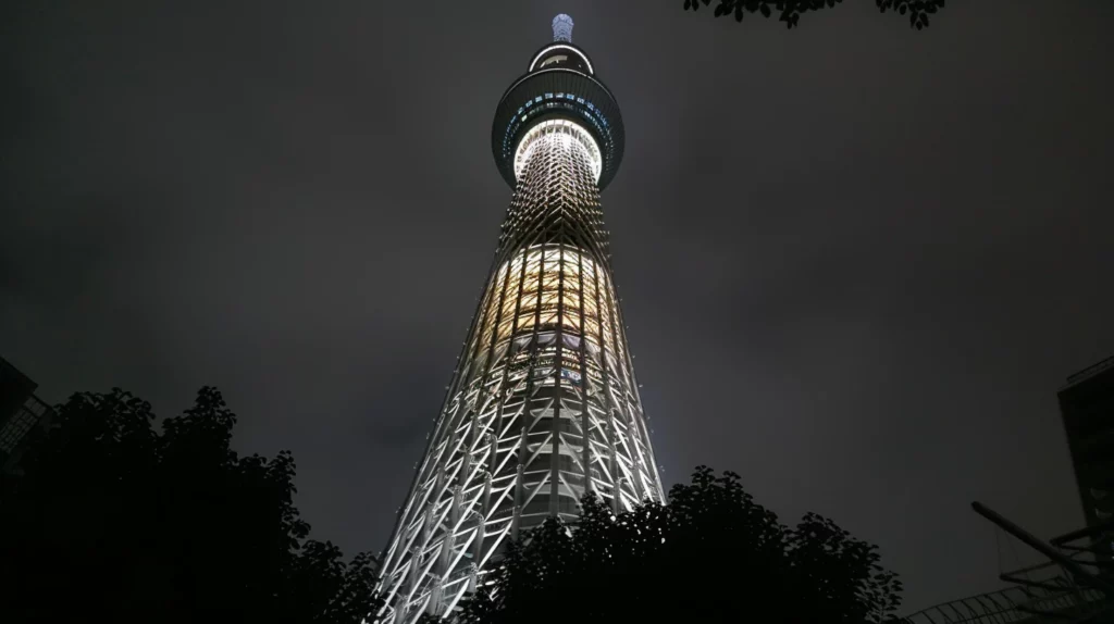 A low-angle shot of the Tokyo Skytree at night