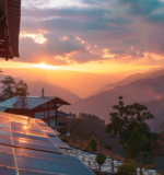 Sunrise over the Himalayas viewed from an eco-chic luxury lodge in Bhutan, highlighting sustainable design and solar panels.