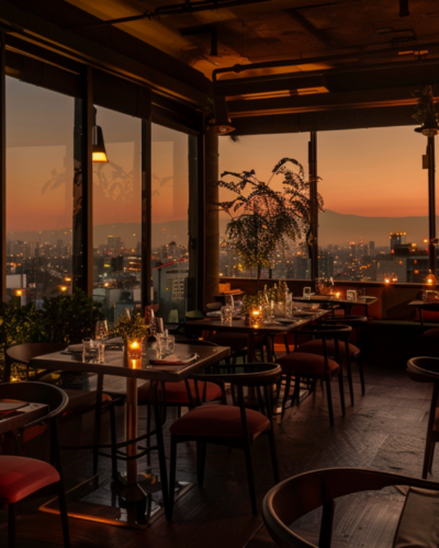 A breathtaking view of a fine dining restaurant at dusk, overlooking the Mexico City skyline