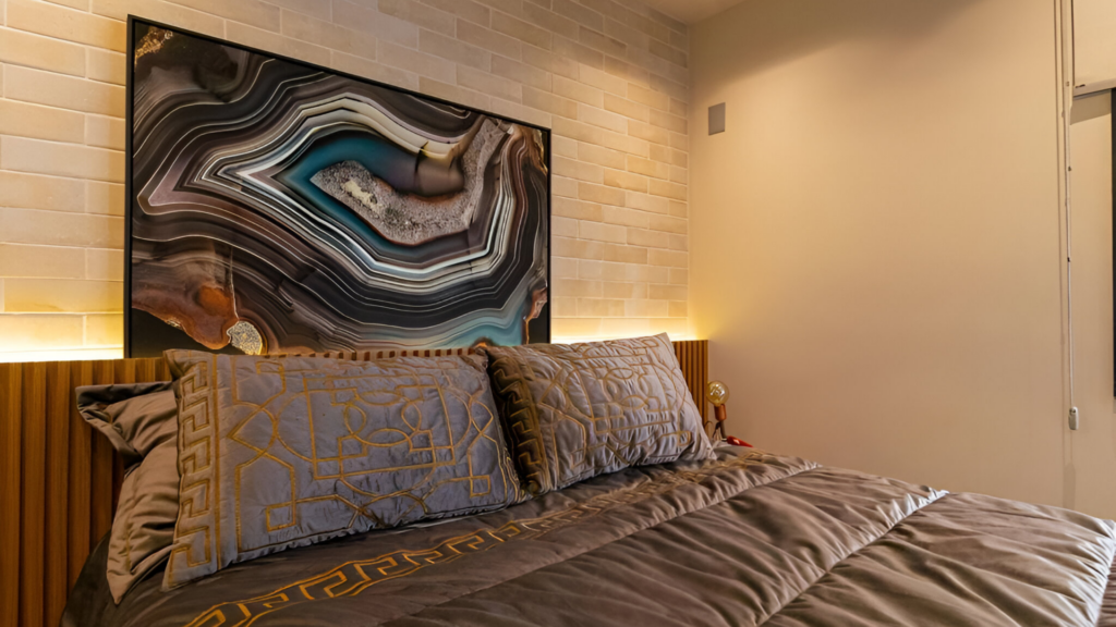 A smart bedroom with an artwork hanging above the headboard