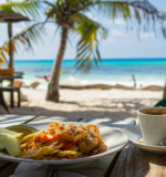 A cup of coffee and a hearty breakfast meal served at a brunch spot in Tulum
