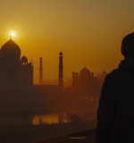 Travelers witnessing the serene beauty of the Taj Mahal at sunrise, capturing a moment of awe and tranquility.