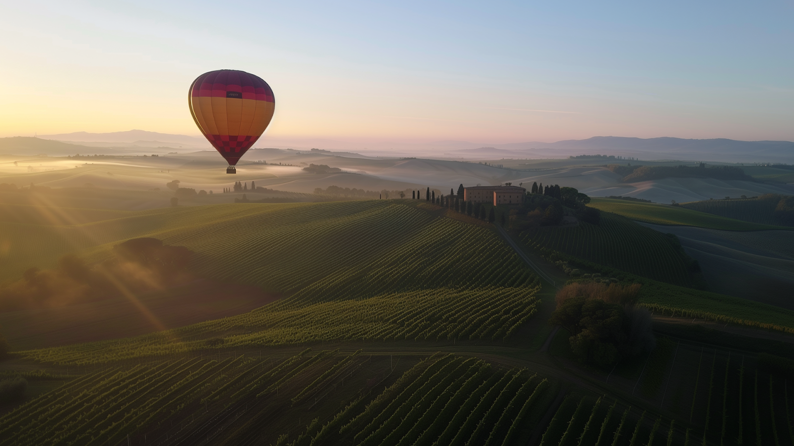 Sunrise hot air balloon ride over Tuscany's vineyard-covered hills.