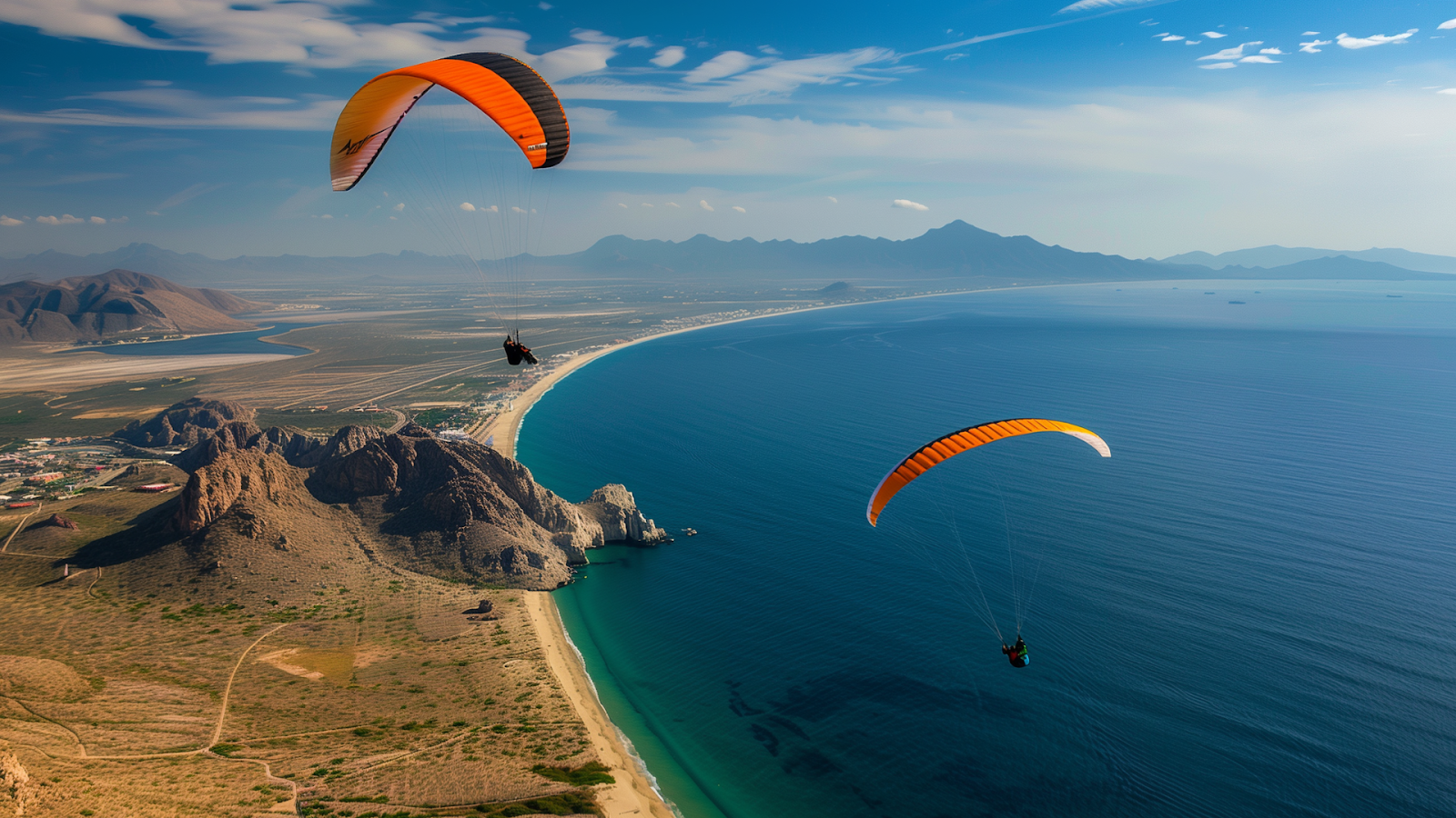 Paragliders soaring above Medano Beach with Sea of Cortez views