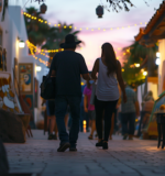 San José del Cabo’s Art Walk at dusk, with lit-up galleries and visitors admiring art.